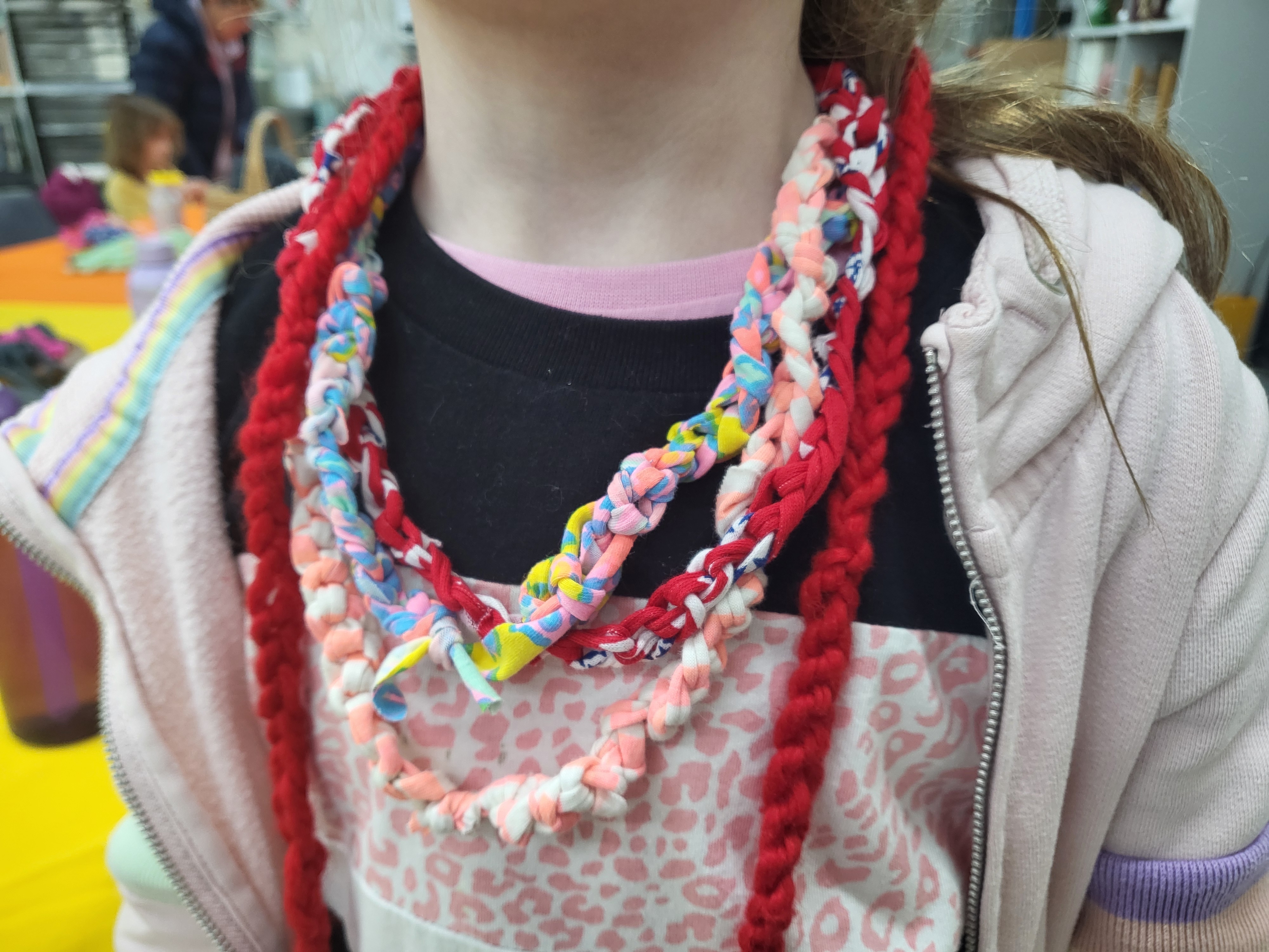 Four different finger knitted necklaces in different colours.