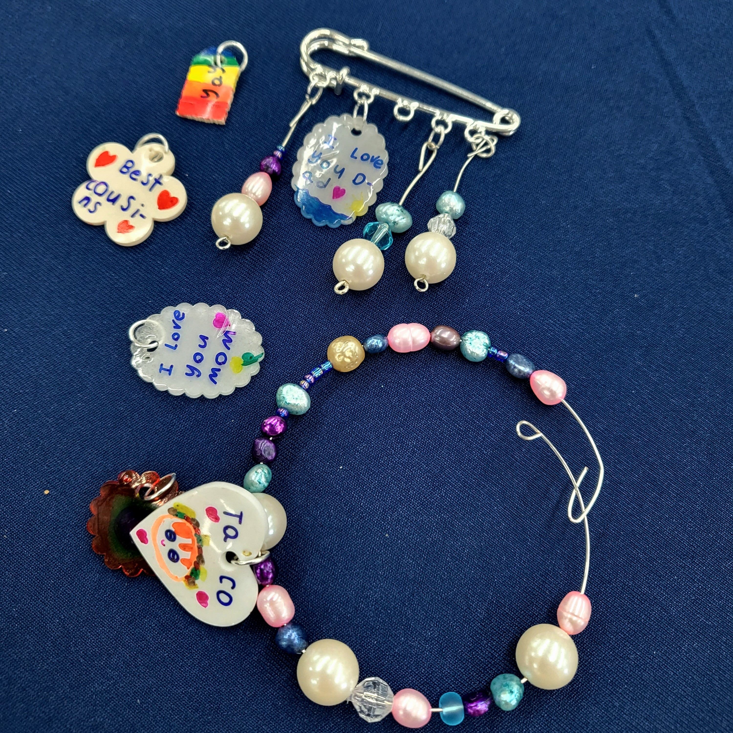 Jewellery made using beads, kilt pins, memory wire and shrink plastic.