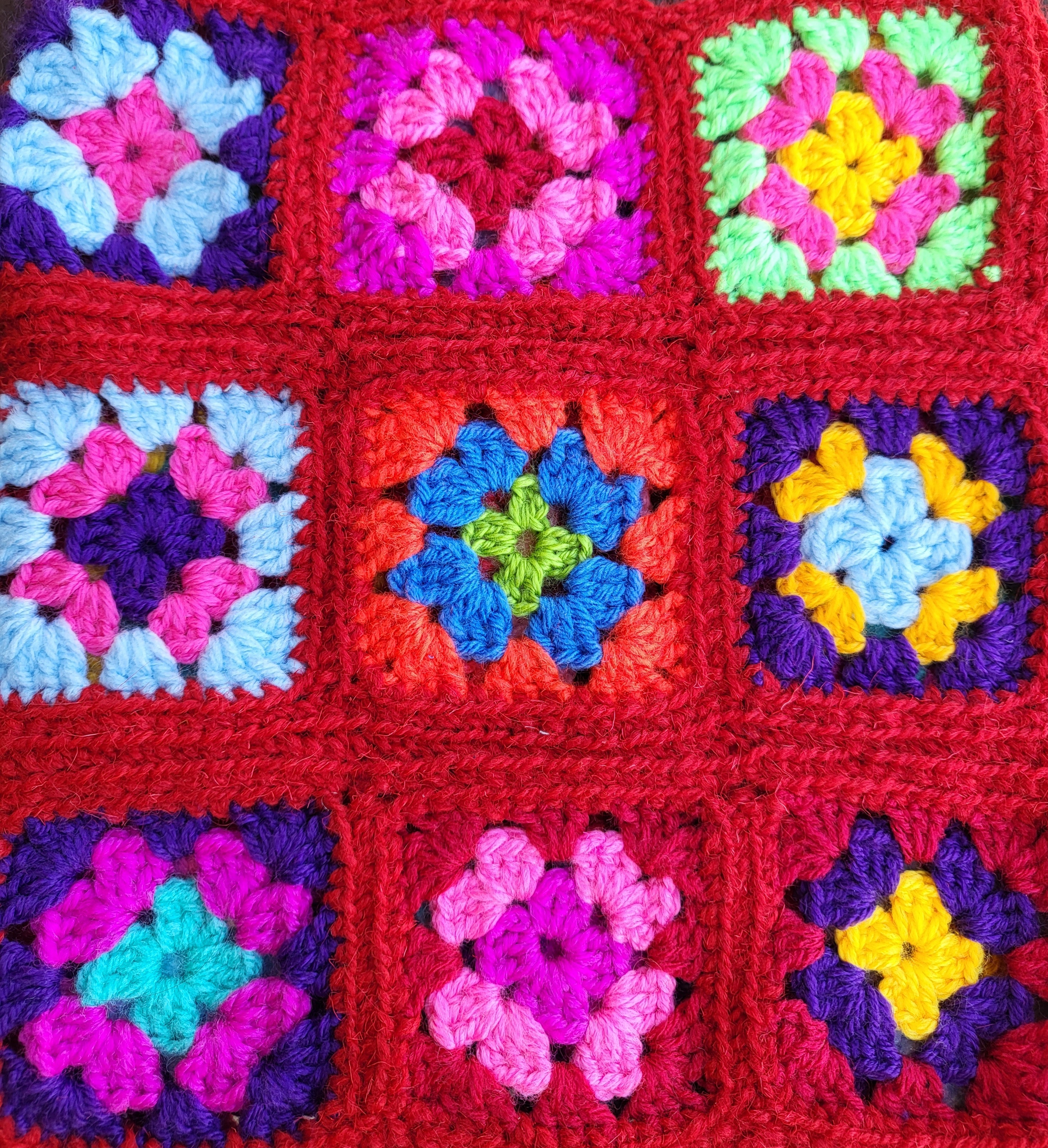 9 crochet squares in various colours (red, pink, blue, yellow and green)