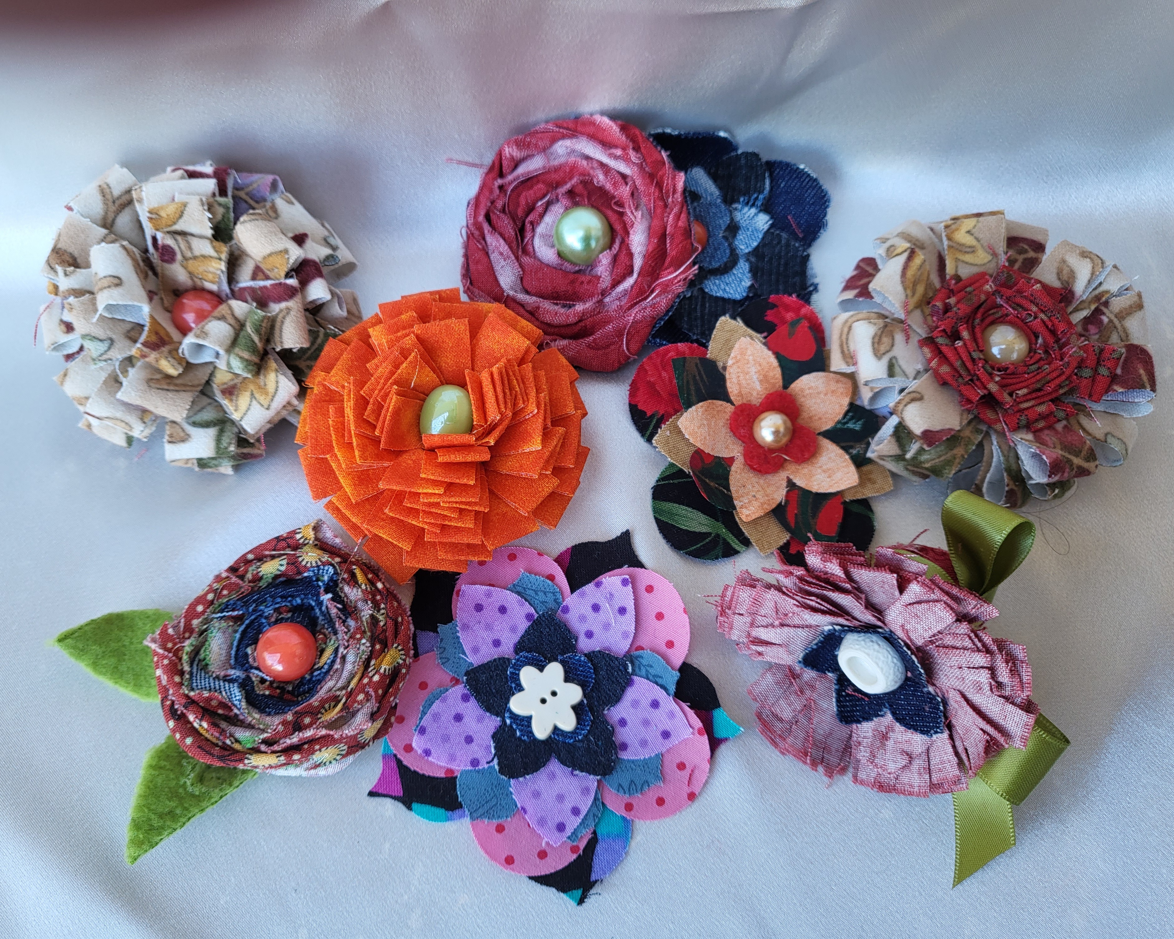 Multiple fabric flowers of many different colours