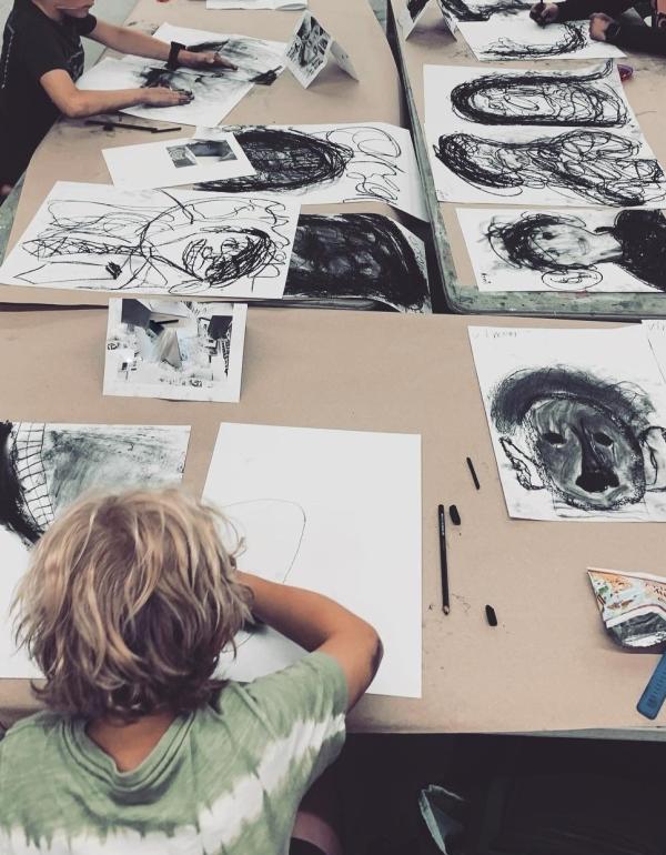 Boy drawing with charcoal