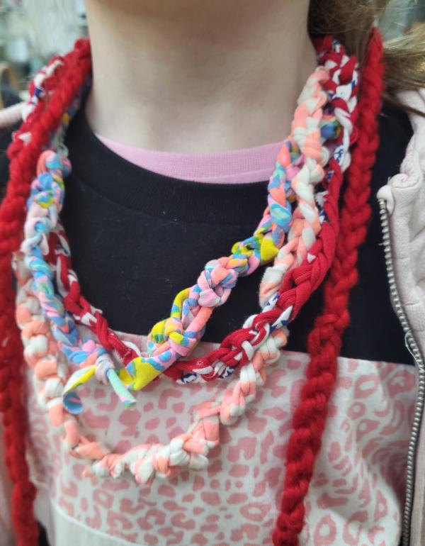 Four different finger knitted necklaces in different colours.