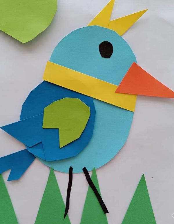 Coloured shapes (yellow, blue, orange and green) used to make a bird.