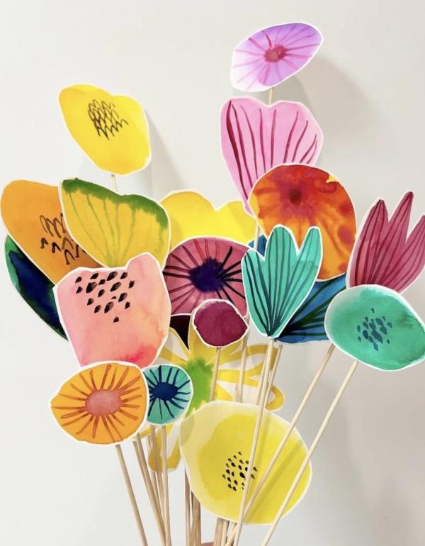 Multiple bright coloured flowers, all on sticks.