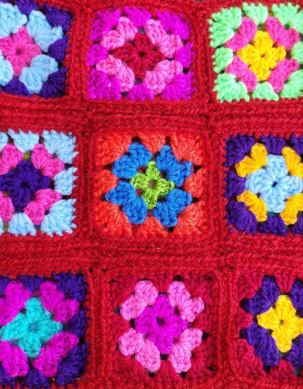9 crochet squares in various colours (red, pink, blue, yellow and green)