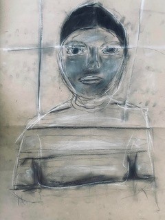 Charcoal drawing of a boy on brown paper