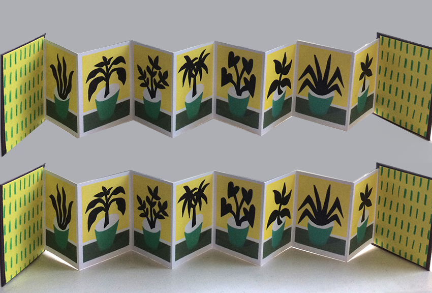 Yellow folded card with flower silhouettes