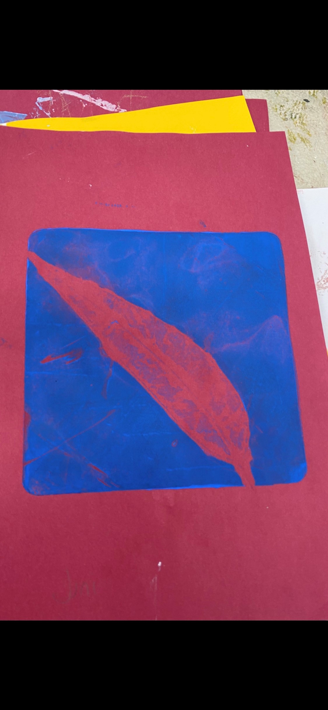 Screen print of a red gum leaf on a blue background