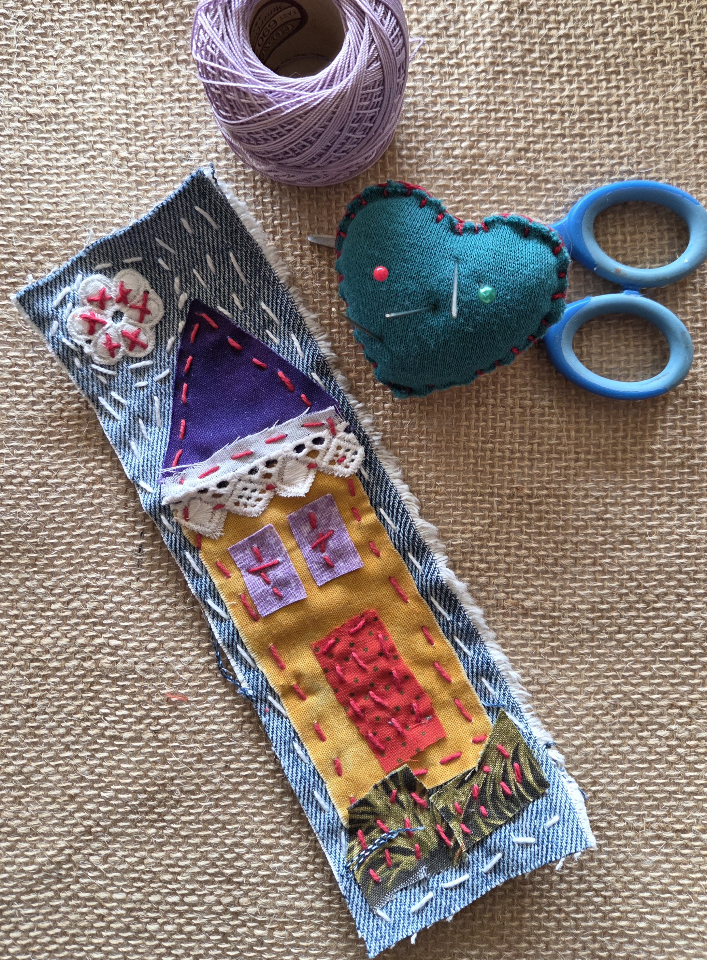 Textile bookmark with house stitched in fabric