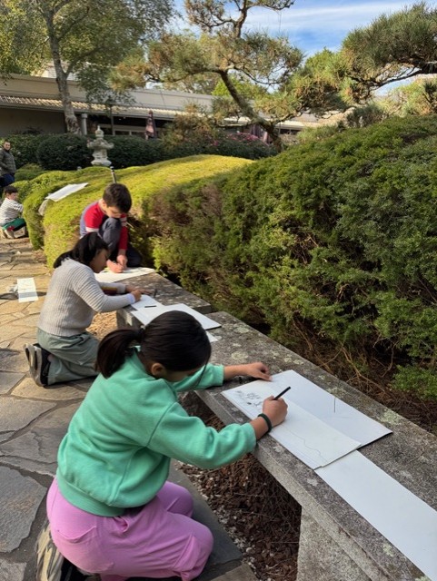 Children drawing in the garden