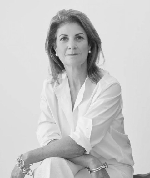 Black and white photo of a woman with her hands crossed