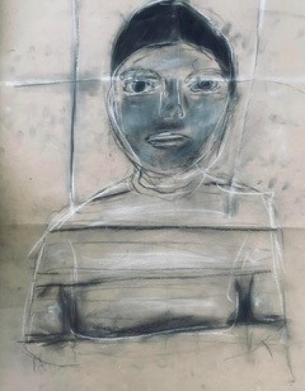 Charcoal drawing of a boy on brown paper