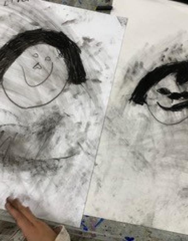 Charcoal drawing of a faces