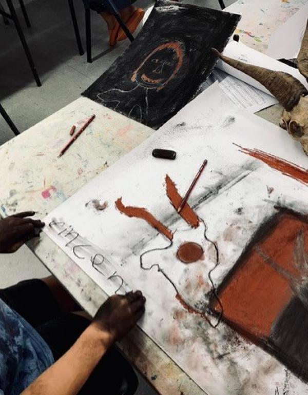 Boy drawing with charcoal