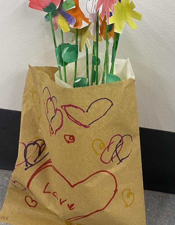 Watercolour flowers cut out and placed in a bag with drawn hearts