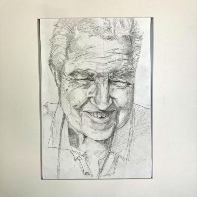 A pencil drawing of a smiling man wearing a collared shirt