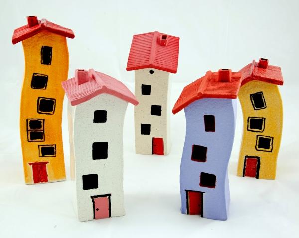 A collection of five colourful, ceramic, multi-story houses