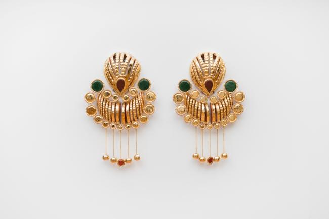 A large artwork shaped like a pair of gold earrings